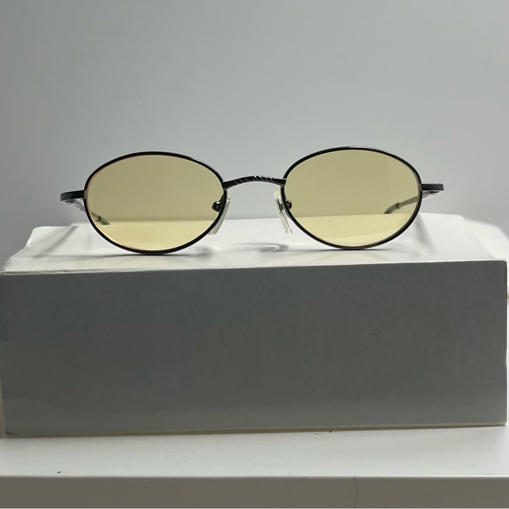 Classy retro dark gray metal frame with light yellow lens.